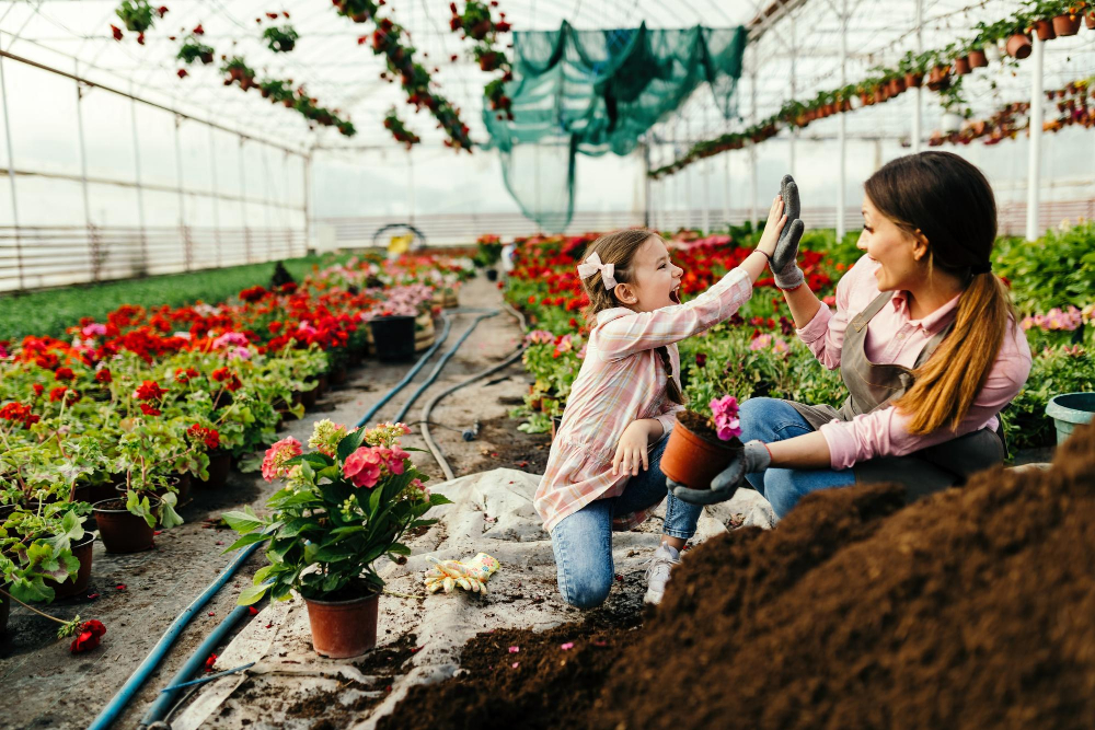 happy-little-girl-her-mother-giving-highfive-each-other-while-planting-flowers-plant-nursery-focus-is-girl
